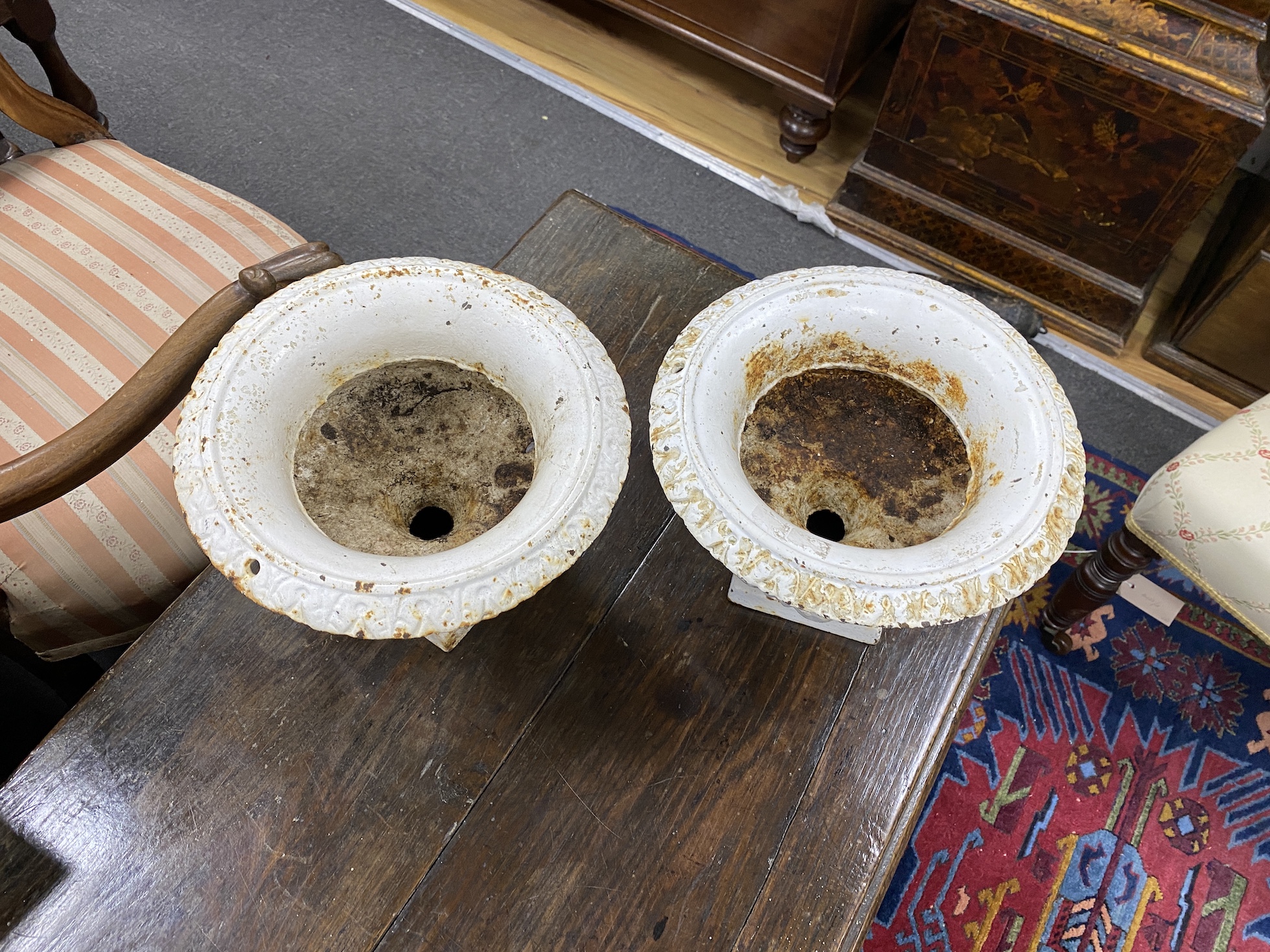 A pair of small Victorian cast iron campana urns, diameter 28cm, height 20cm